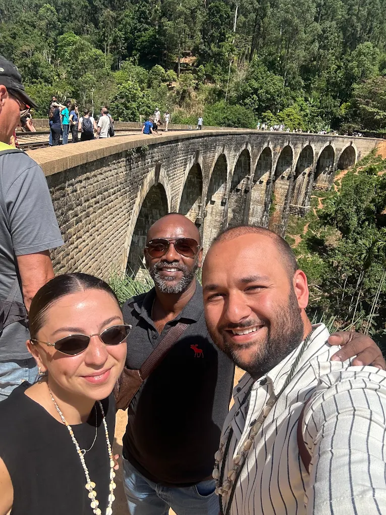 Mahesh with tourists at the famous Nine Arches Bridge in Ella